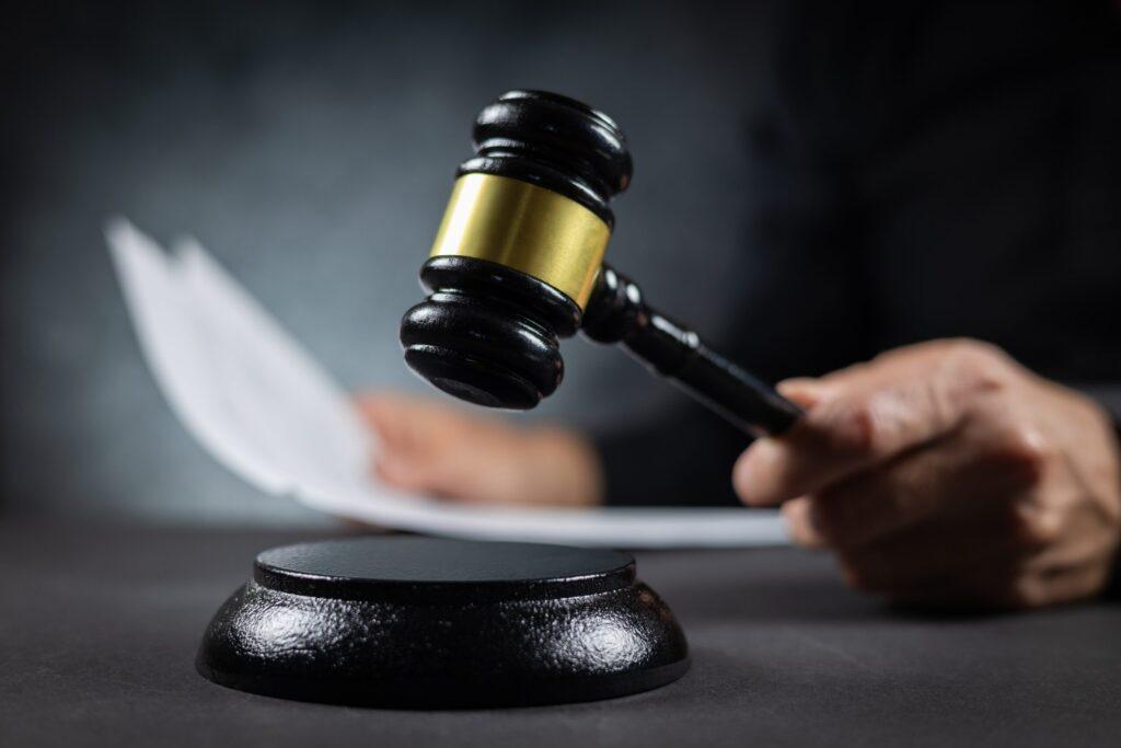 Judge With Paper Document Pronouncing Sentence In A Court