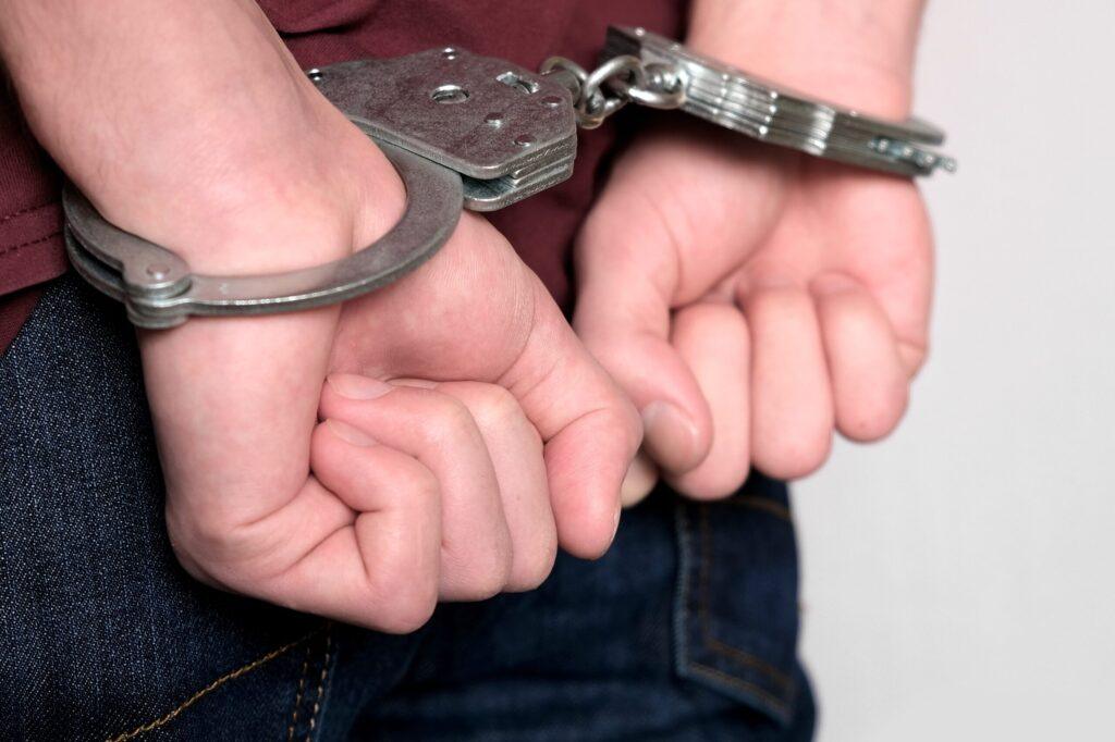 Image of handcuffed hands of man being arrested