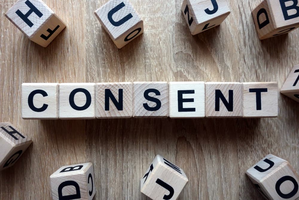 Consent word from wooden blocks on desk