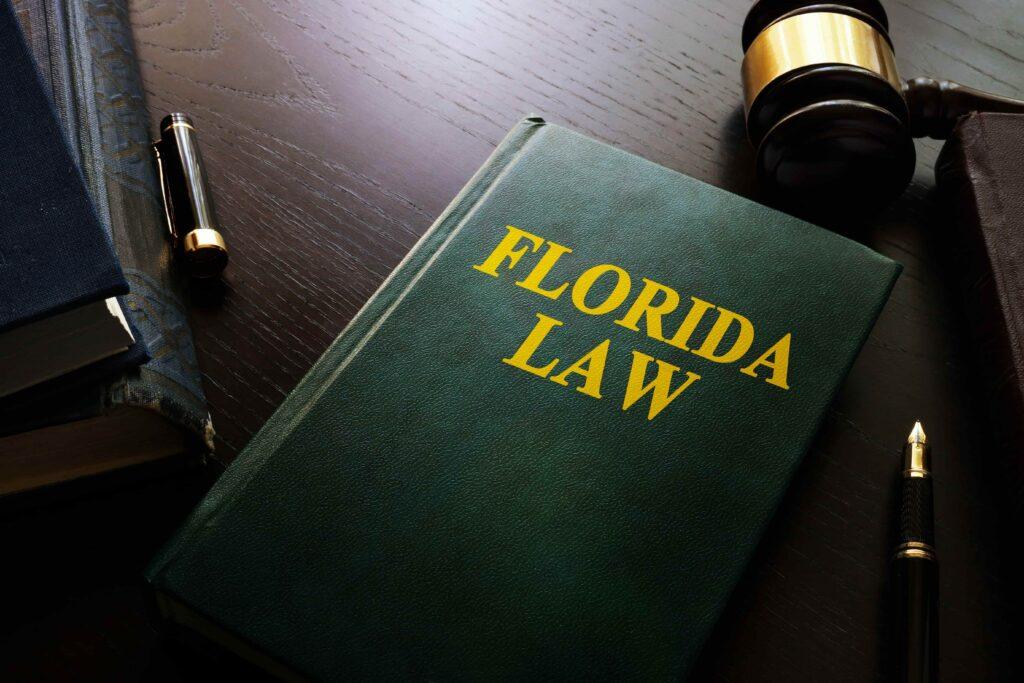 Florida law book with judge gavel and legal documents on desk, representing state legal system and attorneys
