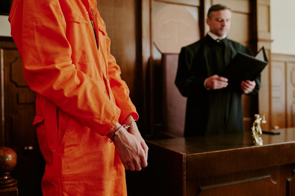 Judge reading from folder at criminal trial